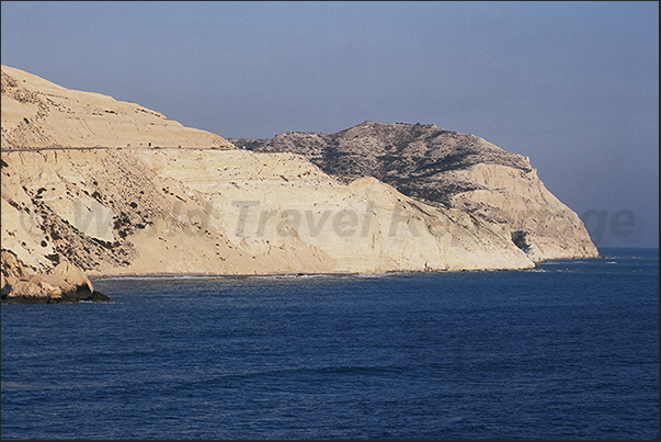 The wild rocky coast of the eastern part of Petra Tou Romiou Bay The wild rocky coast of the eastern part of Petra Tou Romiou Bay