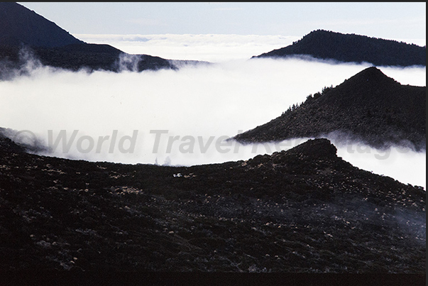 Rocky peaks along the west coast emerge from the sea of clouds that cover the ocean Rocky peaks along the west coast emerge from the sea of clouds that cover the ocean
