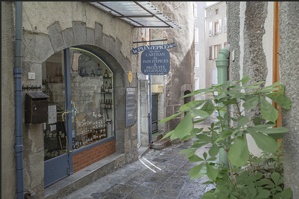 Craft shops overlook the narrow alley of the village