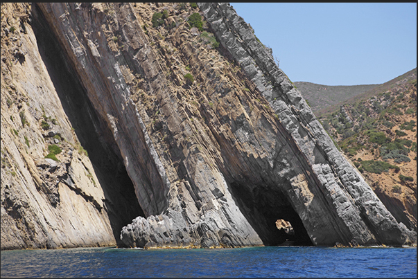 The cliff between the Cala Domestica Bay and the old mine on the sea of Porto Flavia The cliff between the Cala Domestica Bay and the old mine on the sea of Porto Flavia