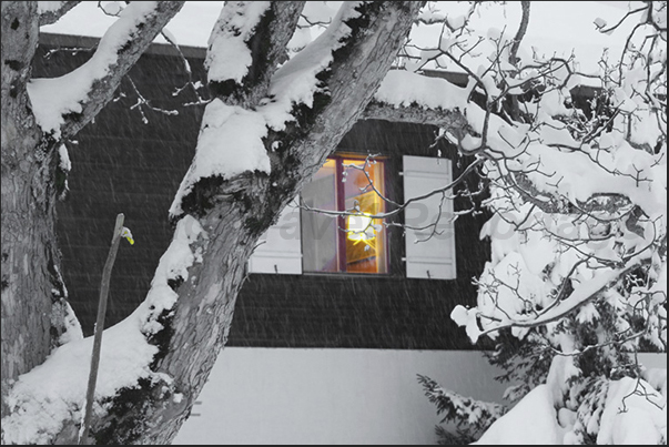 In the evening, the lights that turn in the houses, create suggestive atmospheres of lights and shadows In the evening, the lights that turn in the houses, create suggestive atmospheres of lights and shadows