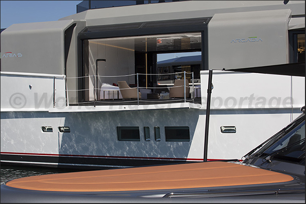 A large terrace opens on the side of a yacht A large terrace opens on the side of a yacht