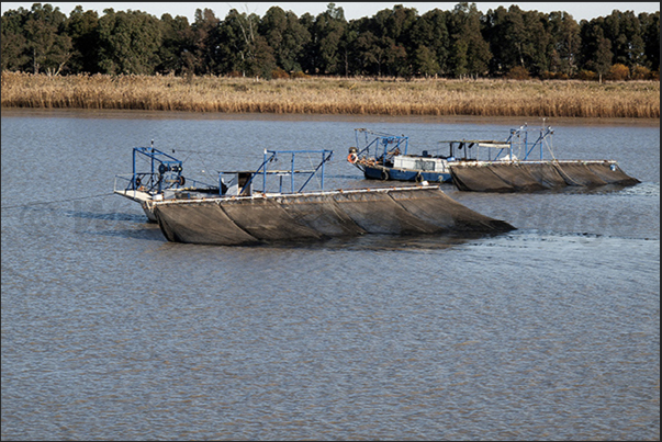 Guadalquivir River. Boats with nets for eel fishing near the village of La Algaida close to the estuary Guadalquivir River. Boats with nets for eel fishing near the village of La Algaida close to the estuary
