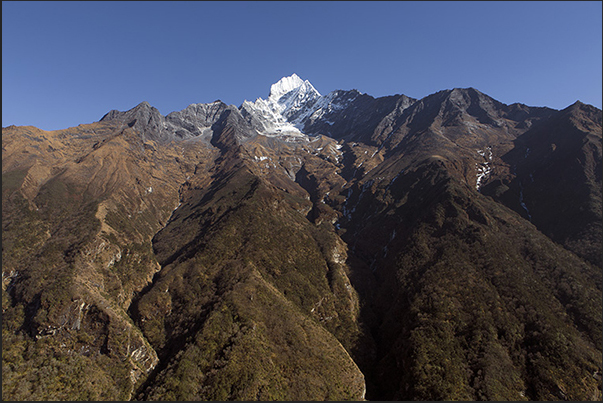 The rugged terrain of the valleys leading to the mountain Thamserku (6618 m) The rugged terrain of the valleys leading to the mountain Thamserku (6618 m)