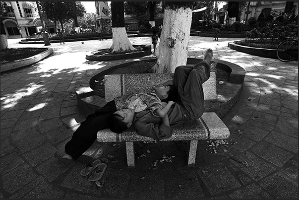 Hanoi. Afternoon nap on a bench in the public gardens Hanoi. Afternoon nap on a bench in the public gardens